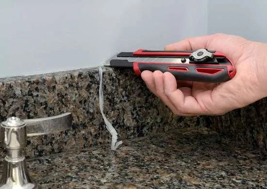 use snap off knife to remove old caulk