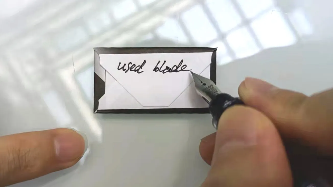 used blade wrapped in paper