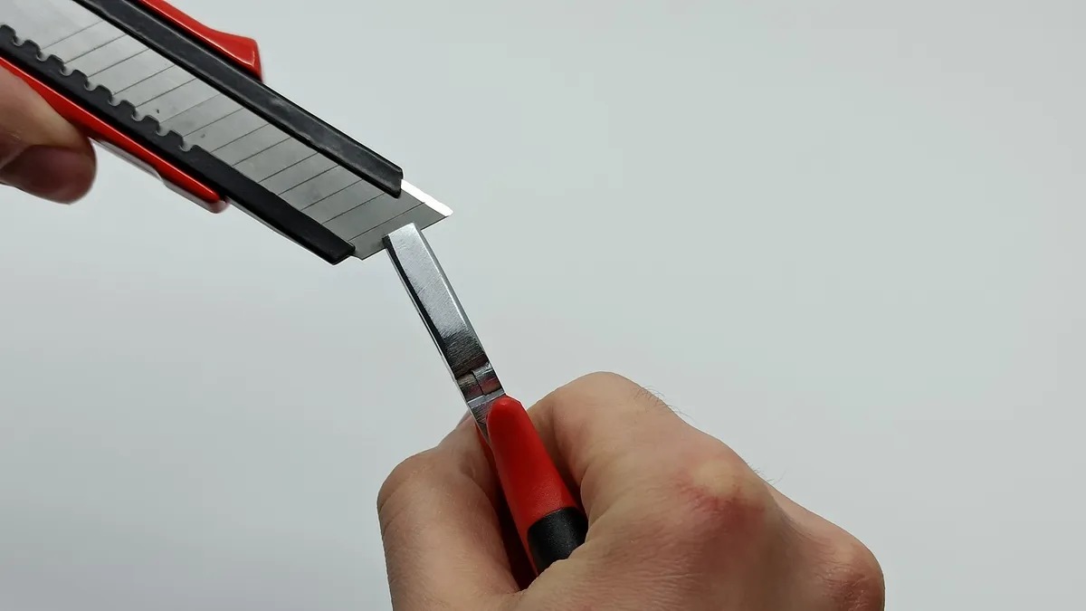 using plier to snap off blade