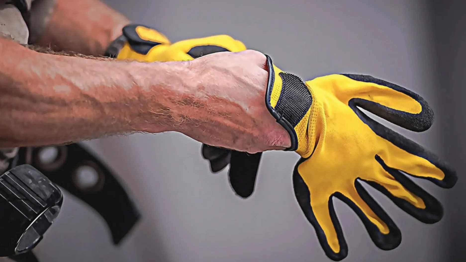 worker putting on gloves